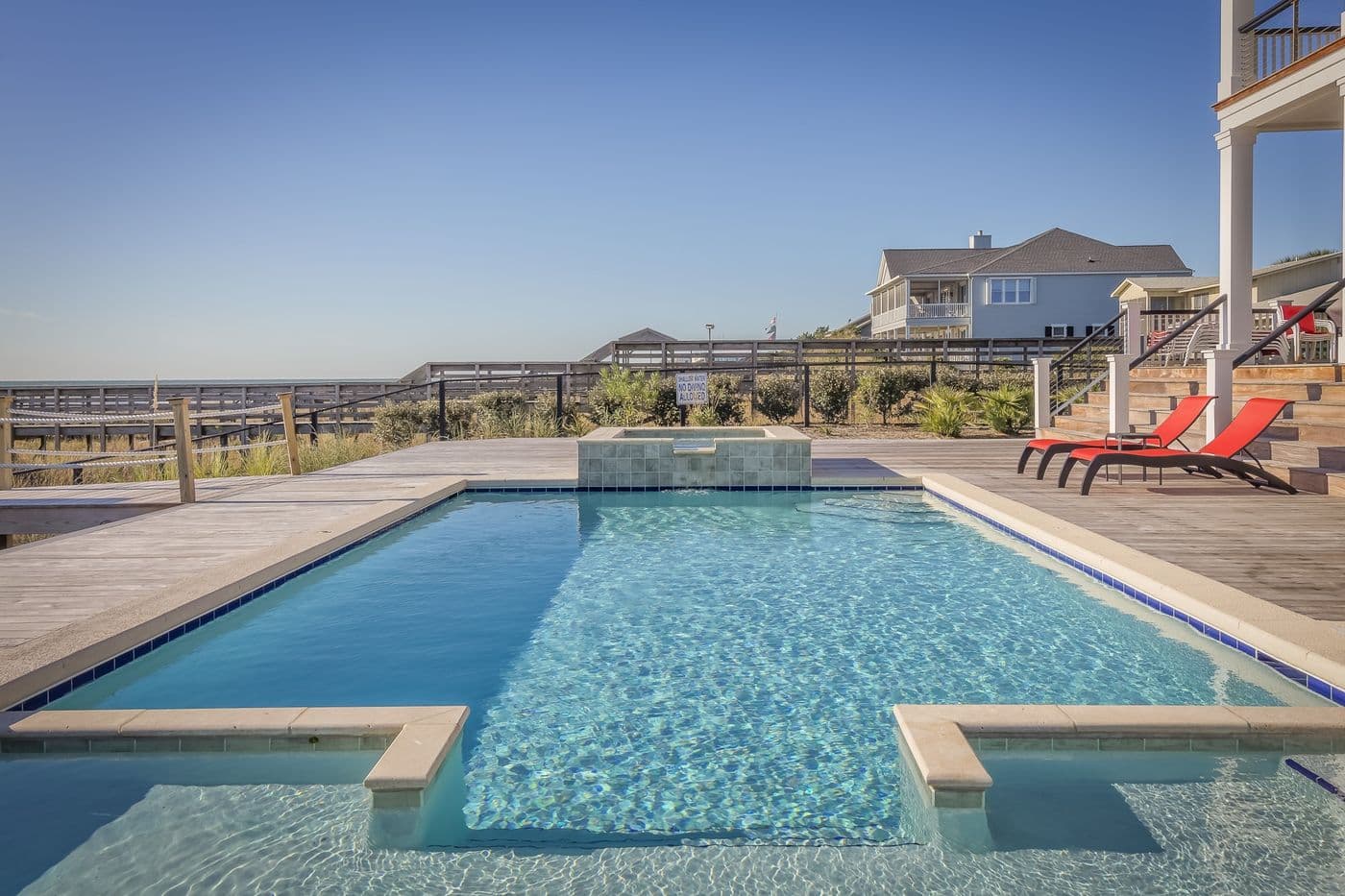 A quiet private garden with an outdoor swimming pool and lawn